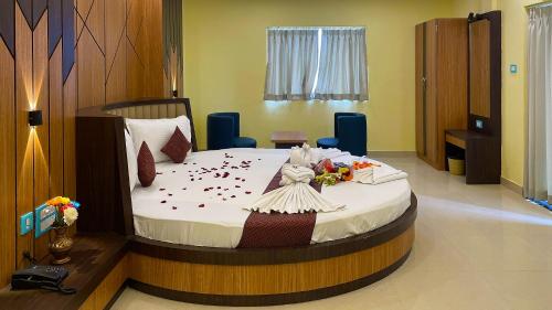 a bedroom with a large bed with flowers on it at Sonargaon Beach Resort in Mandarmoni