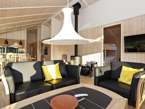 a living room with a couch and a table at Luxury Retreat in Lonstrup - By Traum Ferienwohnungen in Hjørring