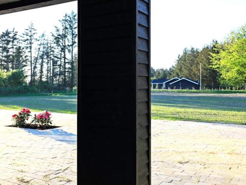 a pole with a pot of flowers on a field at Luxury Retreat in Lonstrup - By Traum Ferienwohnungen in Hjørring