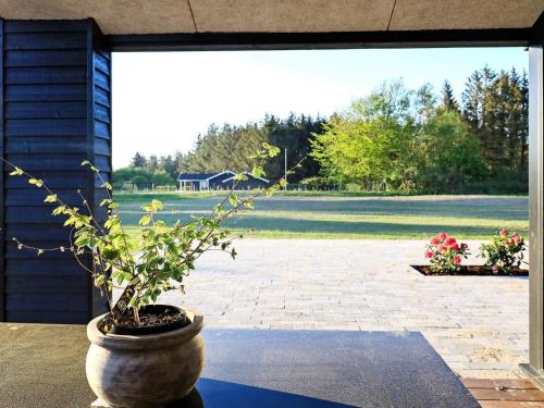 a potted plant in a pot on a patio at Luxury Retreat in Lonstrup - By Traum Ferienwohnungen in Hjørring