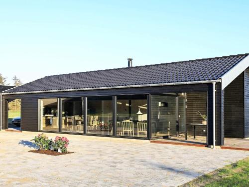 a house with large glass windows and a patio at Luxury Retreat in Lonstrup - By Traum Ferienwohnungen in Hjørring