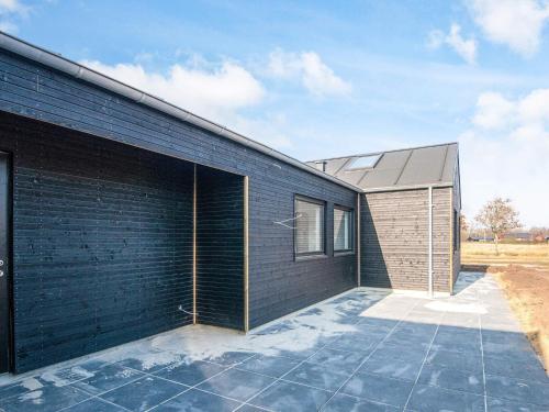 a black brick house with a large garage at 5 star holiday home in Ansager in Ansager