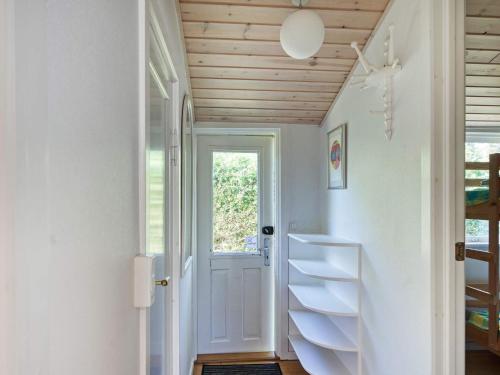 a staircase in a house with a wooden ceiling at Tranquil Beach Retreat - By Traum in Idestrup