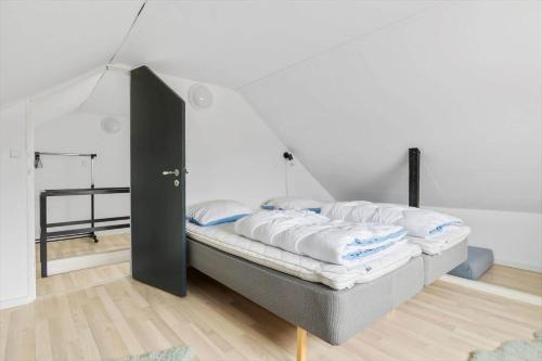 a bed in a room with an open door at TV1654-Albaek-Hovej-3 in Ålbæk
