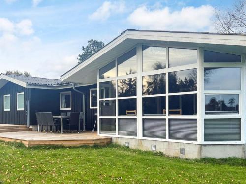a house with a large window and a patio at 8 person holiday home in Sæby in Sæby