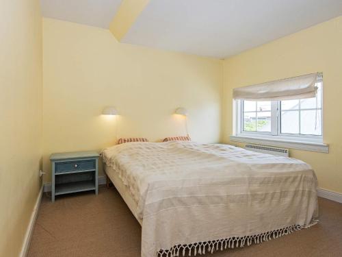 a small bedroom with a bed and a window at 6 person holiday home in Ringkøbing in Ringkøbing