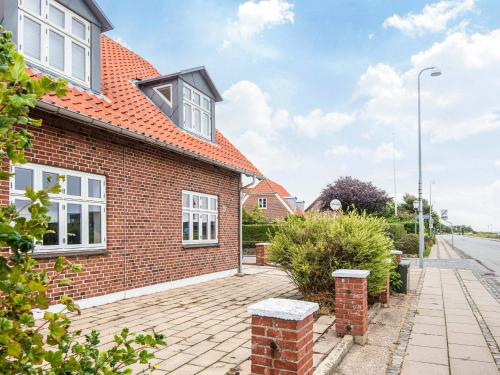 an image of a brick house with a driveway at Holiday apartment near town square in Ringkøbing