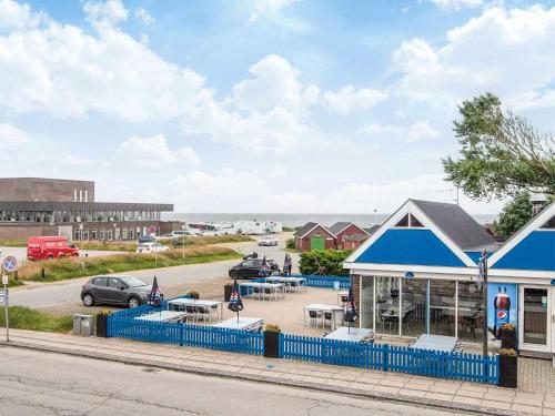 a building with a blue fence next to a street at Holiday apartment near town square in Ringkøbing