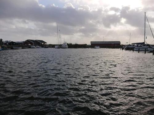 a large body of water with boats in it at Holiday apartment near town square in Ringkøbing