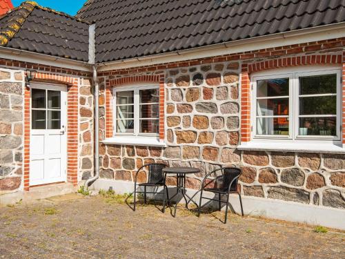 a table and chairs in front of a brick building at Holiday home in Ebeltoft with roof terrace in Ebeltoft