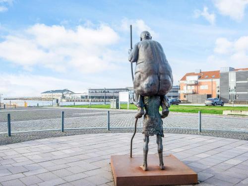 a statue of a man with a backpack on his back at Charming Retreat in Ringkobing in Ringkøbing