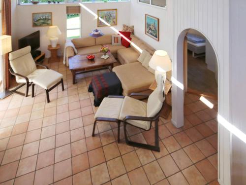 a living room with a couch and chairs and a table at 10 person holiday home in Tisvildeleje in Tisvildeleje