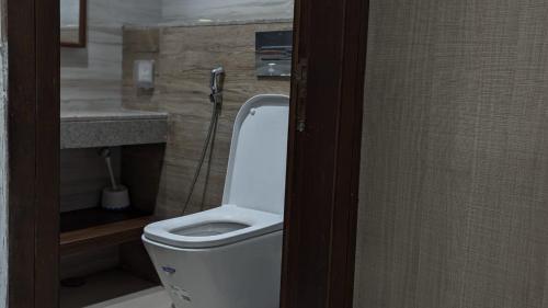 a bathroom with a white toilet and a sink at Premium Guest House - Pentasquare in Lahore