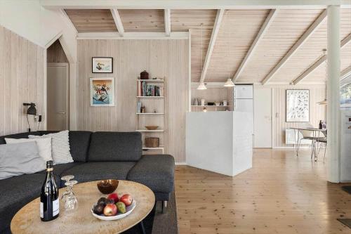 a living room with a couch and a table at TV1660-Albaek-Lyngstien-6-A in Ålbæk