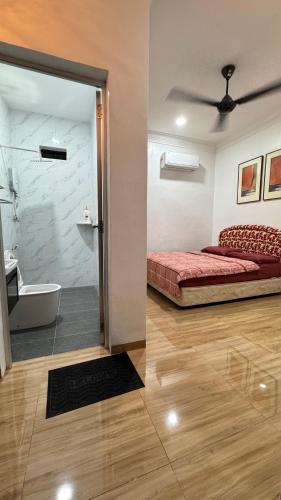 a bedroom with a bed and a bathroom with a tub at D'villa roomstay tangkak in Tangkak