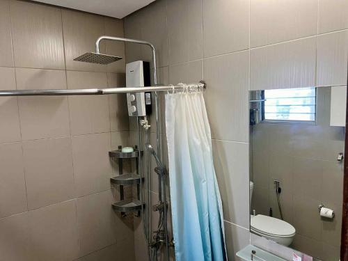 a bathroom with a shower curtain and a toilet at BaseLine Residences 1-Bedroom 10E Internet Netflix in Cebu City