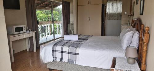 a bedroom with a large bed and a window at The Comfort Zone - Mthatha in Mthatha