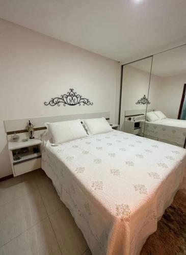 a bedroom with a large bed and a mirror at Apto completo cop 30 in Belém