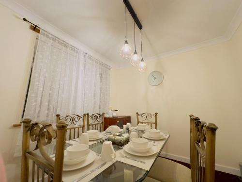 a dining room table with white dishes on it at Harbour Haven North Shields Family & Work Stays in North Shields