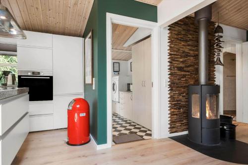 a kitchen with a fireplace and a brick wall at K20042-Gorlev-Avej-23 in Gørlev