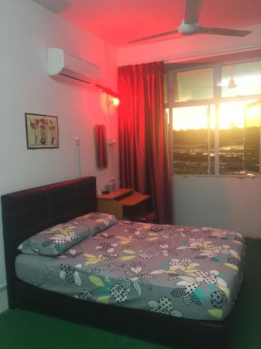 a bedroom with a bed and a window at Tan 8034 SIBU JAYA in Sibu