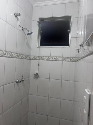 a bathroom with a shower with a television in it at POUSADAS CLUB Dmais1 in Sorocaba