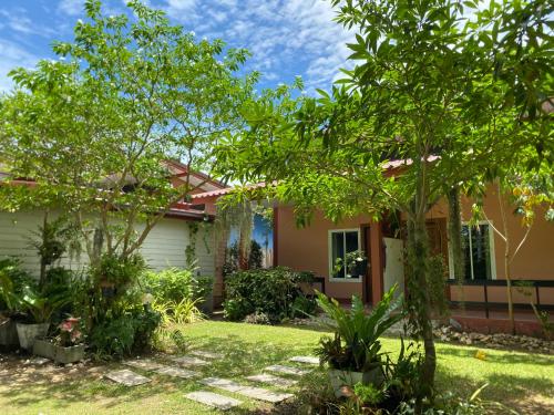 a house with a garden in front of it at Baan Longhaad in Ko Lanta