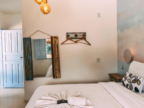 a bedroom with a bed and a mirror at Pousada Vilab in Arraial d'Ajuda