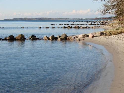a beach with some rocks in the water at SL292-Rude-Skovlobervej-2 in Rude