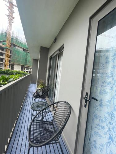 two chairs and a table on a balcony at Loxwood House Luxury Apartment in Accra