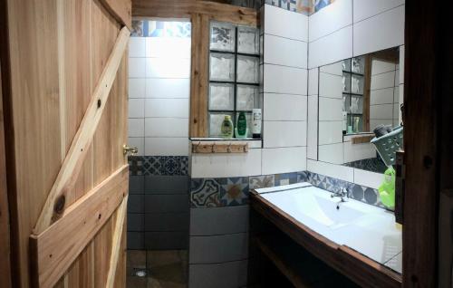 a bathroom with a sink and a mirror at Casa Malagueta in Lajes das Flores