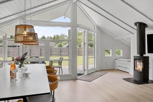 a living room with a table and a fireplace at SL323-Slagelse-Bogfinkevej-29 in Slagelse