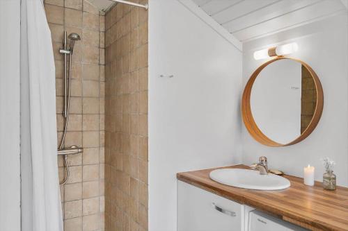 a bathroom with a sink and a mirror at SL323-Slagelse-Bogfinkevej-29 in Slagelse