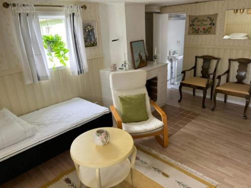 a living room with a bed and a table and chairs at 6 person holiday home in MELLBYSTRAND in Mellbystrand