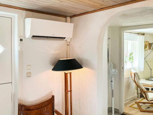 a lamp in the corner of a room at 6 person holiday home in MELLBYSTRAND in Mellbystrand
