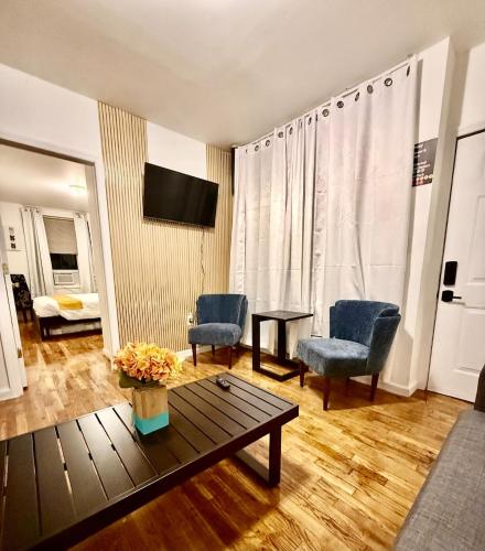 a living room with two chairs and a table at NYCRiverside 2BR Apt 20MintsTime Square in West New York