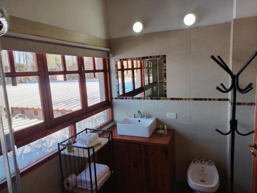 a bathroom with a sink and a mirror at Posada Cavieres Wine Farm in Maipú