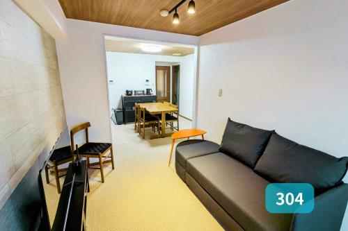 a living room with a couch and a dining room at Nishi-Funabashi Residence in Funabashi