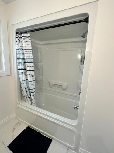 a bathroom with a shower with a shower curtain at Modern Luxurious Stay in Amherstburg