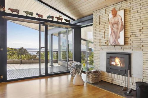 a living room with a fireplace and a view at K19016-Kalundborg-Klintedalsvej-37 in Kalundborg