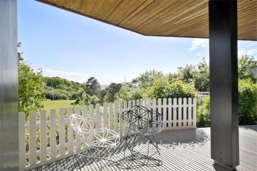 a white chair sitting on a porch next to a white fence at K19016-Kalundborg-Klintedalsvej-37 in Kalundborg