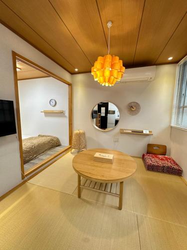 a room with a table and a bed and a mirror at Tsubame Hotel Asakusabashi 3 minutes walk from Asakusabashi Station Near Asakusa, Akihabara, and Ueno Cooking utensils and kitchen washing machine available Direct access to Haneda and Narita airports in Tokyo