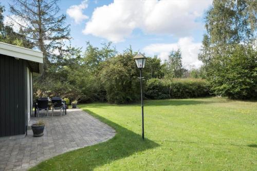 a street light in the grass next to a house at K19070-Eskebjerg-Marsvej-3 in Eskebjerg