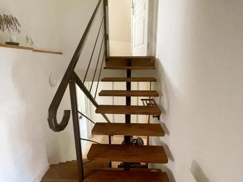 a wooden staircase in a room with a window at Gîte paisible 2 chambres près de Tours et Amboise - FR-1-381-628 in Azay-sur-Cher
