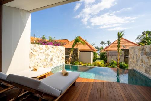 a view of the pool from the patio of a villa at Amarta Beach Retreat by Nakula in Tabanan