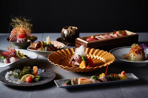 a table topped with plates of food and a box at 山人 Oga in Oga