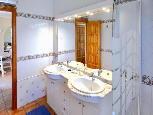 a bathroom with two sinks and a shower at Family Villa with Valley Views in Rojales