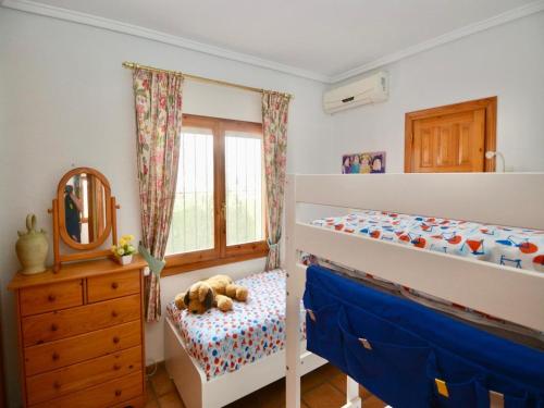 a bedroom with two bunk beds and a mirror at Family Villa with Valley Views in Rojales