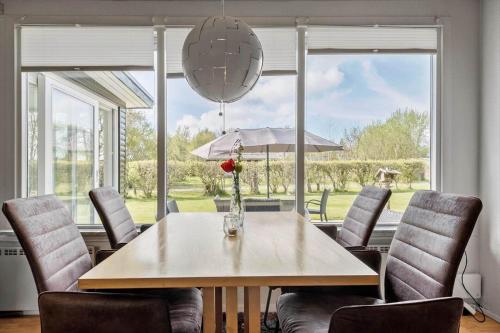 a dining room with a table and chairs and a large window at K20086-Store-Fuglede-Aengsvej-10 in Store Fuglede