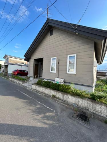 a house on the side of a street at sukeemon in Biei